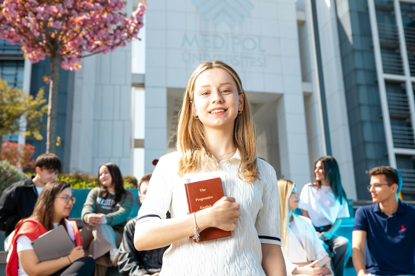 students socializing at university campus outdoors